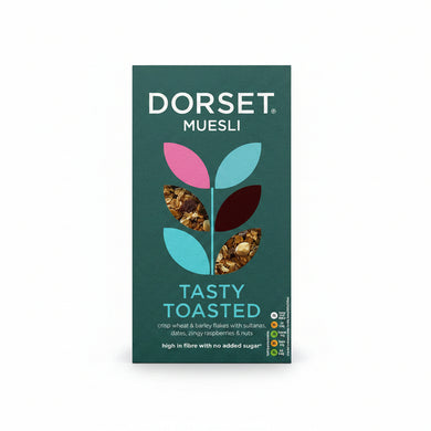 Front of a Dorset Muesli box for Tasty Toasted, showing a dark teal background with a stylized leaf logo filled with cereal pieces and product text.